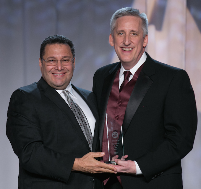 RCI’s Gordon Gurnik (right) receives the ACE Employer award from Ken Potrock, senior vice president and general manger of Disney Vacation Club